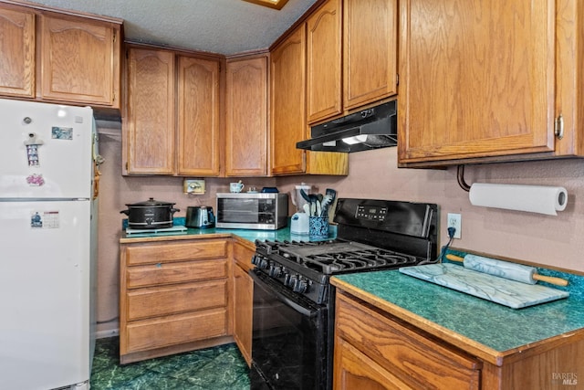 kitchen featuring a textured ceiling, white fridge, and black range with gas cooktop