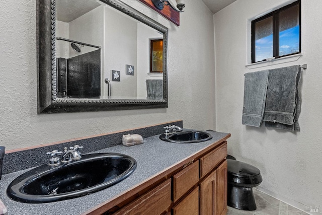 bathroom featuring vanity, toilet, and walk in shower