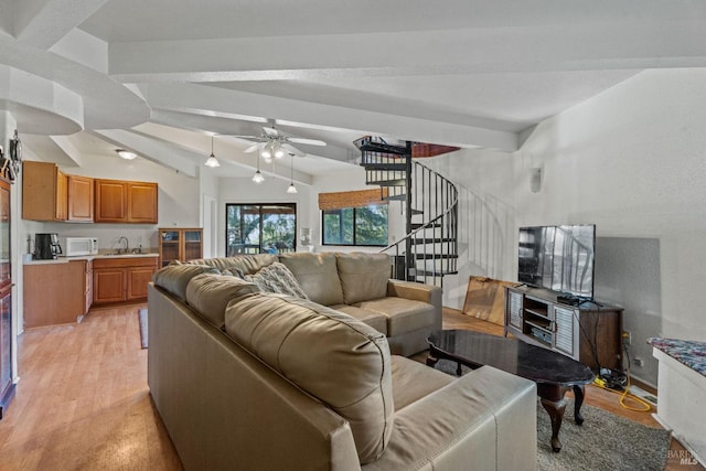 living room featuring ceiling fan, sink, lofted ceiling with beams, and light wood-type flooring