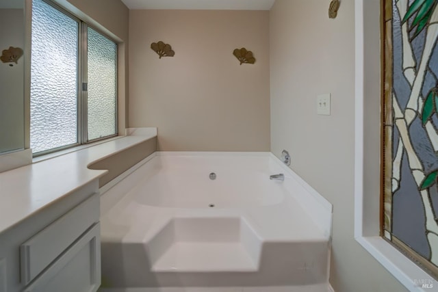 bathroom with vanity and a bathtub