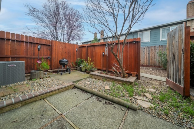 view of patio featuring central AC unit and a grill