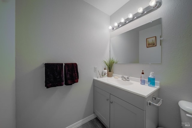 bathroom with vanity and toilet