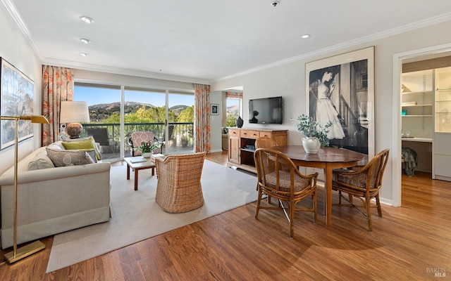 living room featuring ornamental molding and light hardwood / wood-style floors