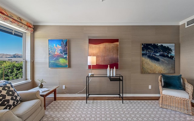 living area with ornamental molding and wood-type flooring