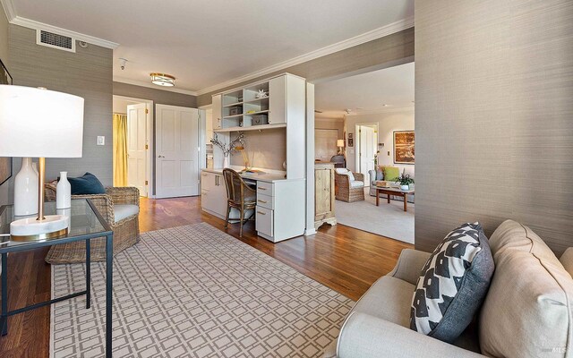 living room with dark hardwood / wood-style flooring and ornamental molding