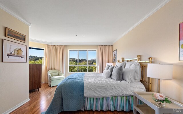 bedroom featuring hardwood / wood-style floors and ornamental molding