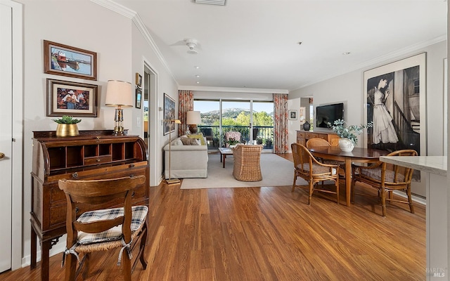 living room featuring ornamental molding and light hardwood / wood-style flooring