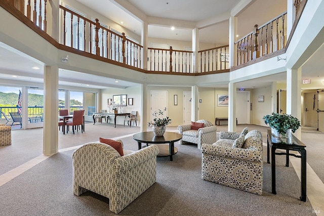 living room featuring light carpet and a high ceiling