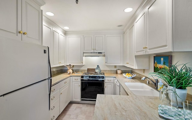 kitchen with light stone counters, sink, white refrigerator, white cabinets, and black electric range oven