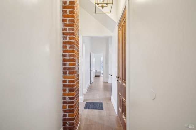 hallway with light hardwood / wood-style flooring