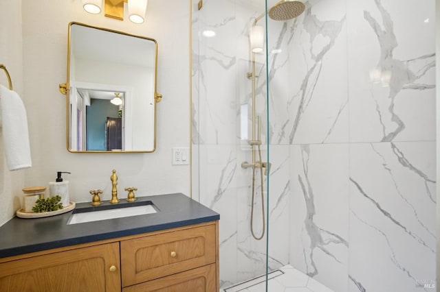 bathroom with vanity and a tile shower