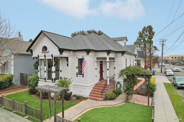 view of front of house with a pergola and a front yard