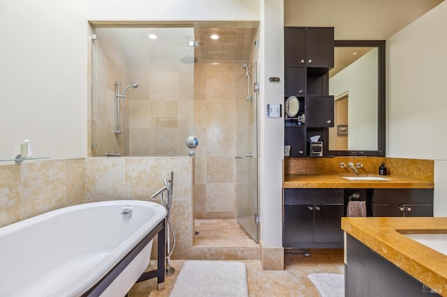 bathroom with tile patterned floors, vanity, and shower with separate bathtub