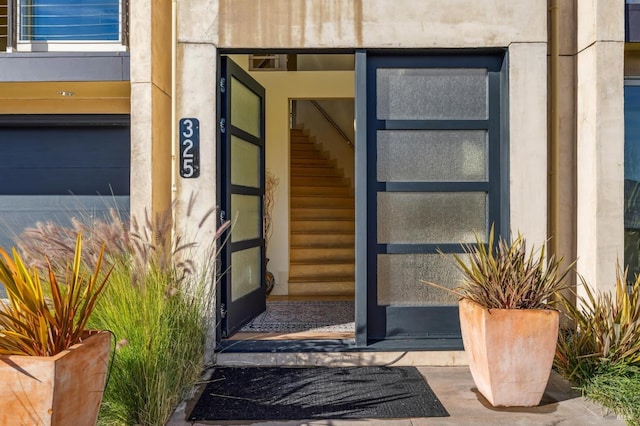 doorway to property with a garage