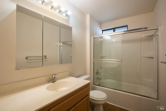 full bathroom with vanity, toilet, and bath / shower combo with glass door