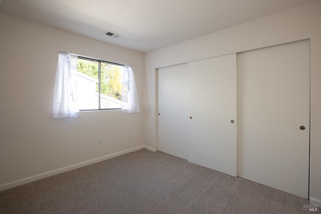 unfurnished bedroom with carpet floors and a closet