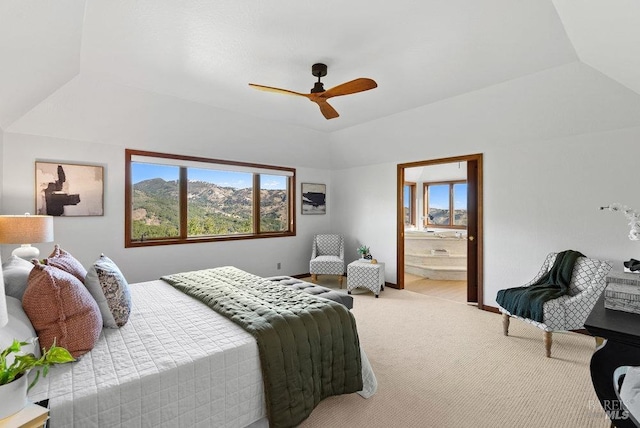 bedroom featuring ceiling fan, light colored carpet, connected bathroom, and multiple windows