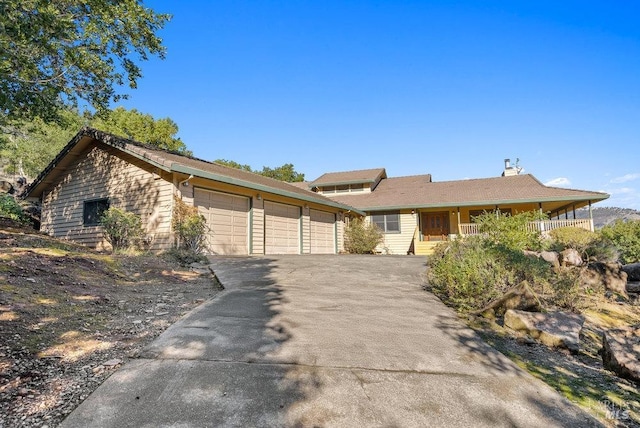 single story home with covered porch and a garage