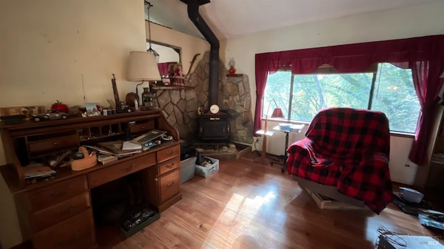 interior space featuring light hardwood / wood-style floors and a wood stove