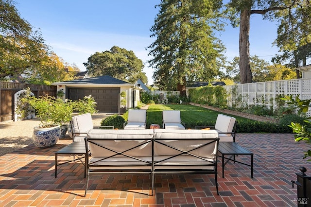 view of patio with outdoor lounge area and a garage