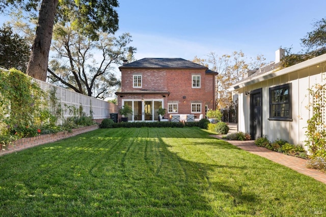 rear view of property featuring a yard