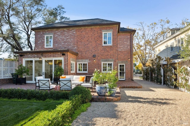 back of property featuring an outdoor living space and a patio area