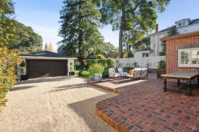 view of patio featuring an outdoor hangout area, a garage, and an outdoor structure