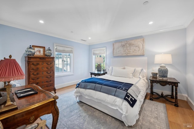 bedroom with wood-type flooring and crown molding