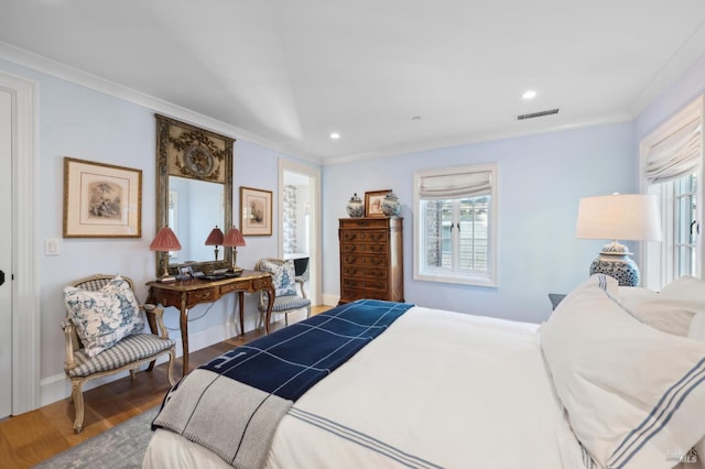 bedroom with crown molding and wood-type flooring