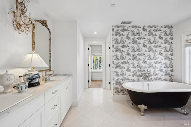 bathroom featuring tile patterned floors, vanity, and a tub