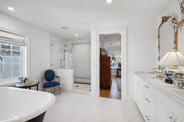 bathroom with tile patterned floors, vanity, and separate shower and tub