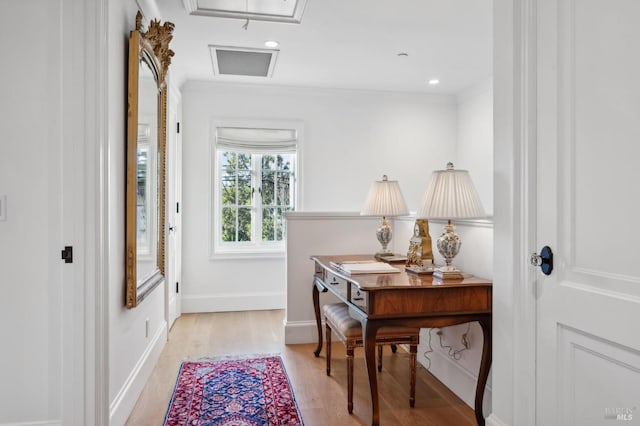 doorway to outside featuring light wood-type flooring and ornamental molding