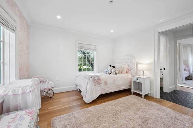 bedroom with hardwood / wood-style flooring and ornamental molding