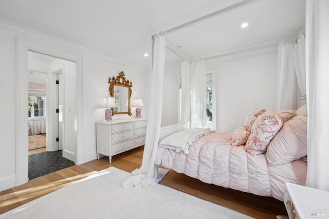 bedroom featuring crown molding and wood-type flooring