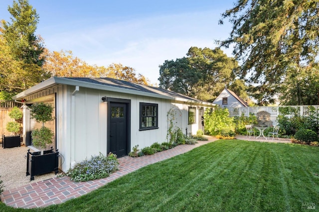 view of yard featuring a patio and an outdoor structure