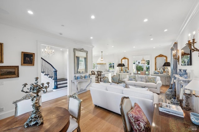 living room featuring light hardwood / wood-style floors and crown molding