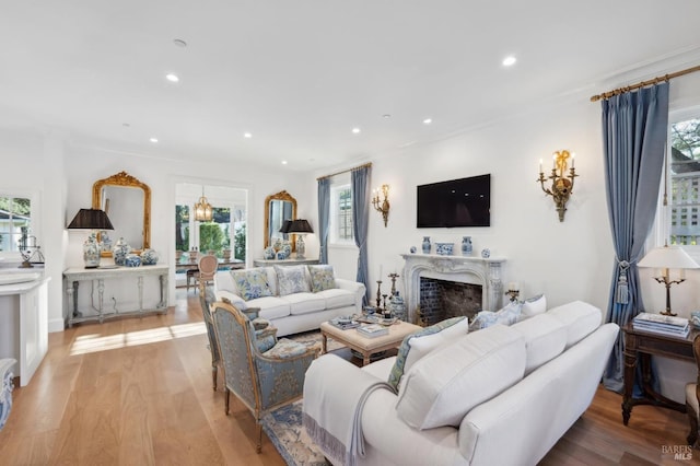 living room with light hardwood / wood-style flooring and ornamental molding