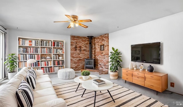 living room with light carpet, a wood stove, and ceiling fan