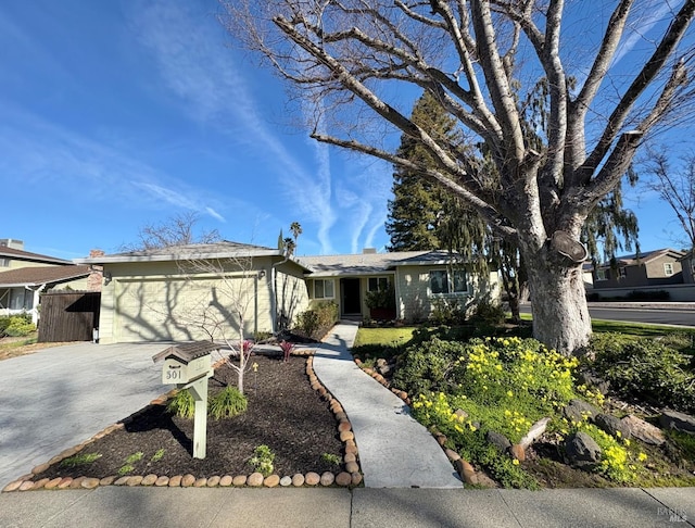 single story home with a garage and driveway