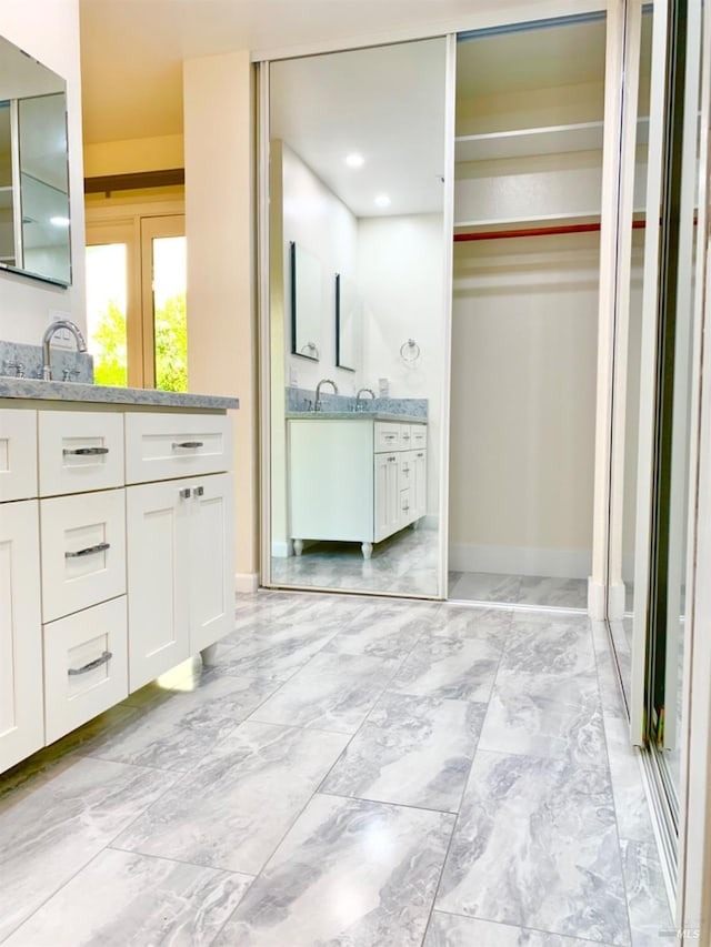 bathroom featuring vanity and an enclosed shower