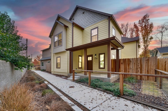 view of front of home featuring fence private yard and covered porch