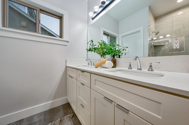 bathroom featuring a wealth of natural light, a shower with door, and vanity