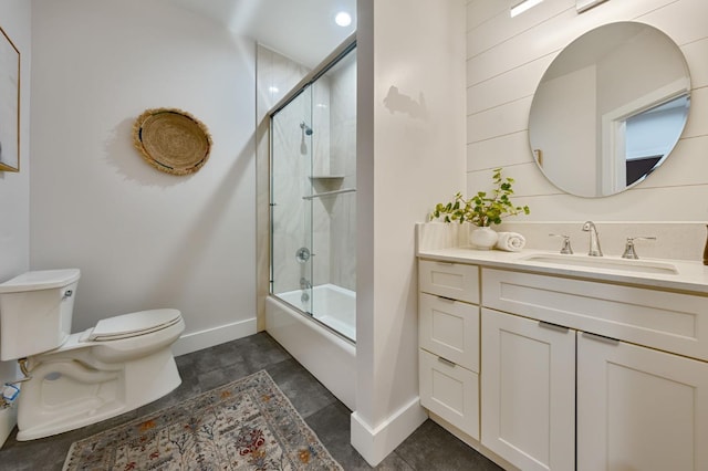 full bathroom featuring toilet, bath / shower combo with glass door, and vanity