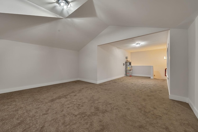 additional living space featuring lofted ceiling, water heater, and carpet floors