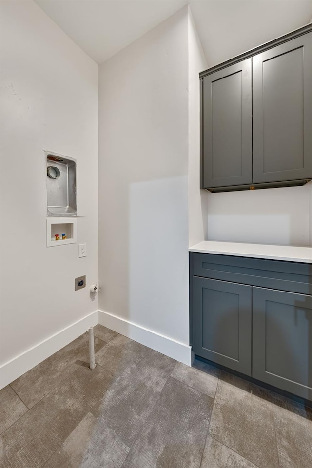 washroom featuring washer hookup, cabinets, and hookup for an electric dryer