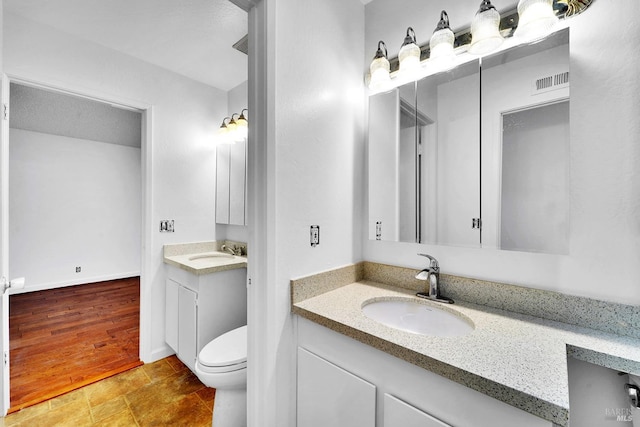 bathroom with vanity and toilet