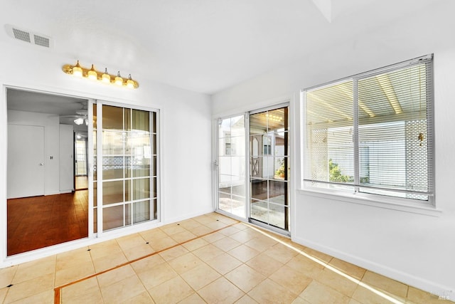 interior space with ceiling fan and light tile patterned floors