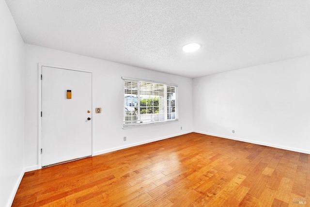 entrance foyer featuring a textured ceiling and light hardwood / wood-style flooring