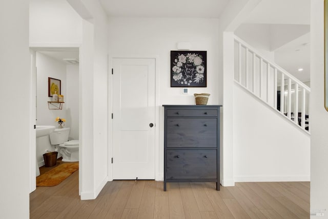 hall with hardwood / wood-style flooring