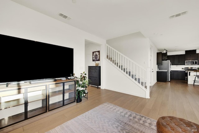 living room with light hardwood / wood-style floors